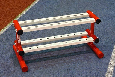 Red and white painted stand with 18 holes on lower and upper levels to hold javelins when not in use.   Includes a galvanised handle and wheels to allow the trolley to be stored away from the throwing area.