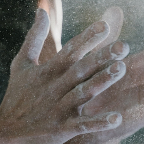 Athlete putting chalk on hands