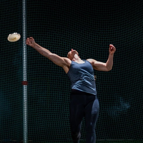 Athletic woman throwing discus