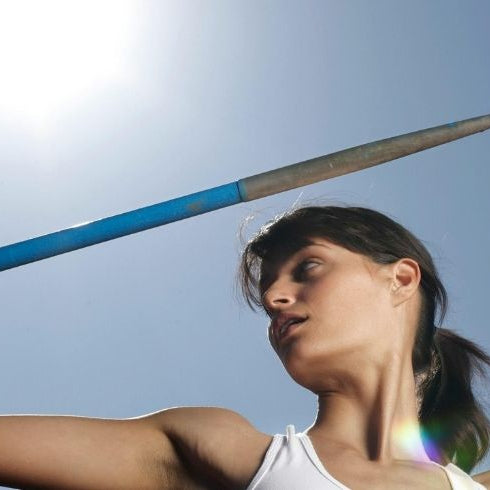 lady holding a blue javelin with sunshine behind