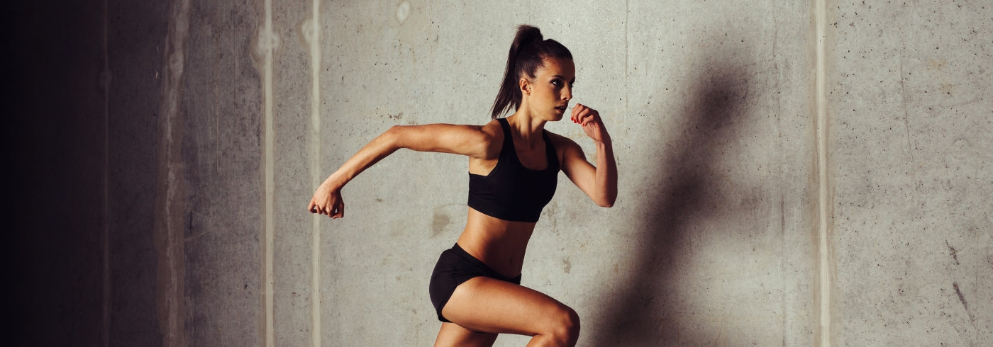 Young female sprinter running