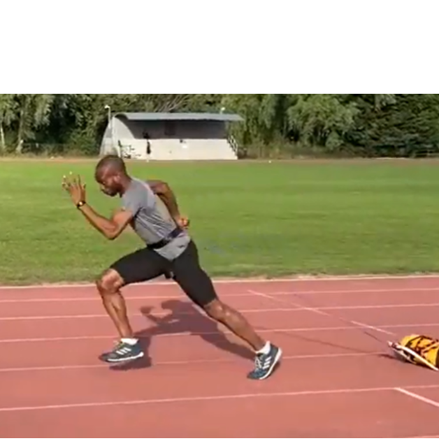 Athlete practicing acceleration drills with a power sledge resistance harness