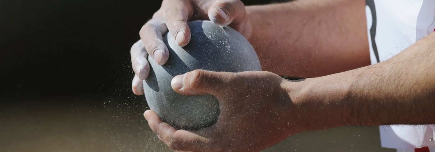 grey shot held in a mans hand