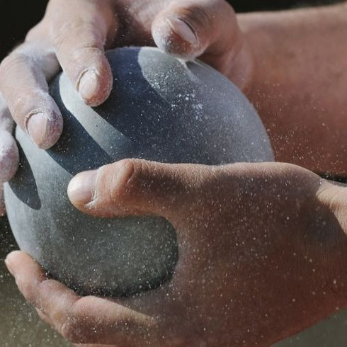 grey shot held in a mans hand