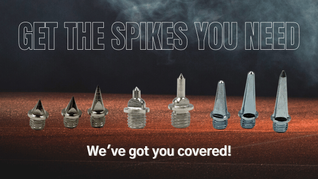 Row of steel running spikes pins of different sizes