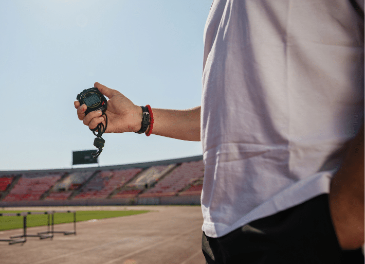 Athletics official holding a stopwatch