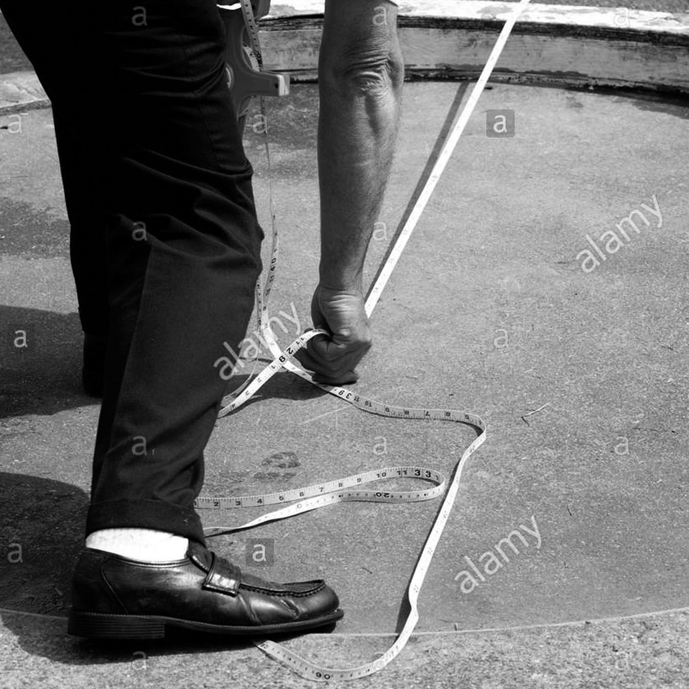 Close up of athletics official measuring with a tape measure