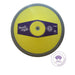 A yellow and gray discus throw shown from a top-down view on a white background, featuring a purple central label with the Nordic Sports brand logo and a World Athletics Certified Product seal.