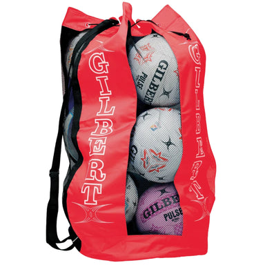 Red Gilbert ball bag with black shoulder strap and mesh  front to see netballs through it. On a white background