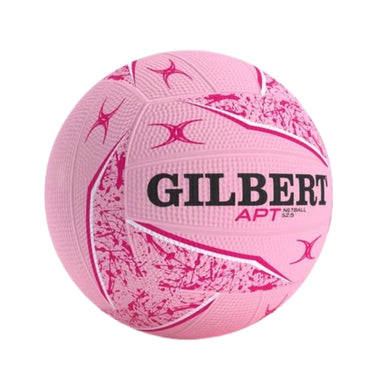 A pink Gilbert APT netball ball with black and pink branding and textured panels, isolated on a white background.