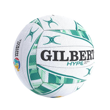 A white Netball with green geometric patterns and black text reading 'GILBERT' and 'HYPE', photographed on a plain white background.