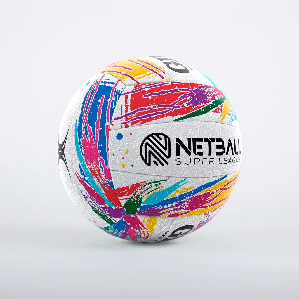 A white Gilbert netball with a vibrant multicolor paint-splatter pattern and the words 'NETBALL SUPER LEAGUE' printed in bold black letters on the front, set against a white background.