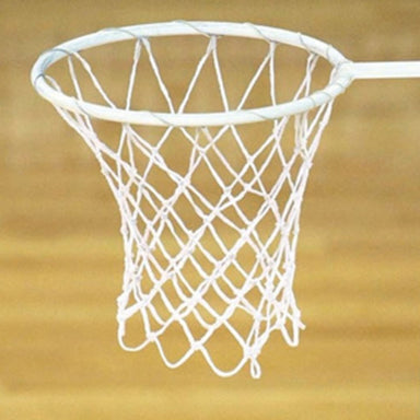A white netball hoop with a white net, shown against a warm brown wooden background.