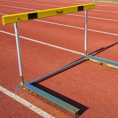 Yellow and silver hurdle with Neuff branding on a running track
