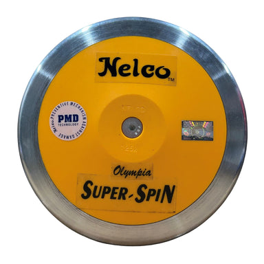 A Nelco Olympia Super-Spin discus with a bright yellow centre, a polished silver metal rim, and black branding text, shown on a plain white background.