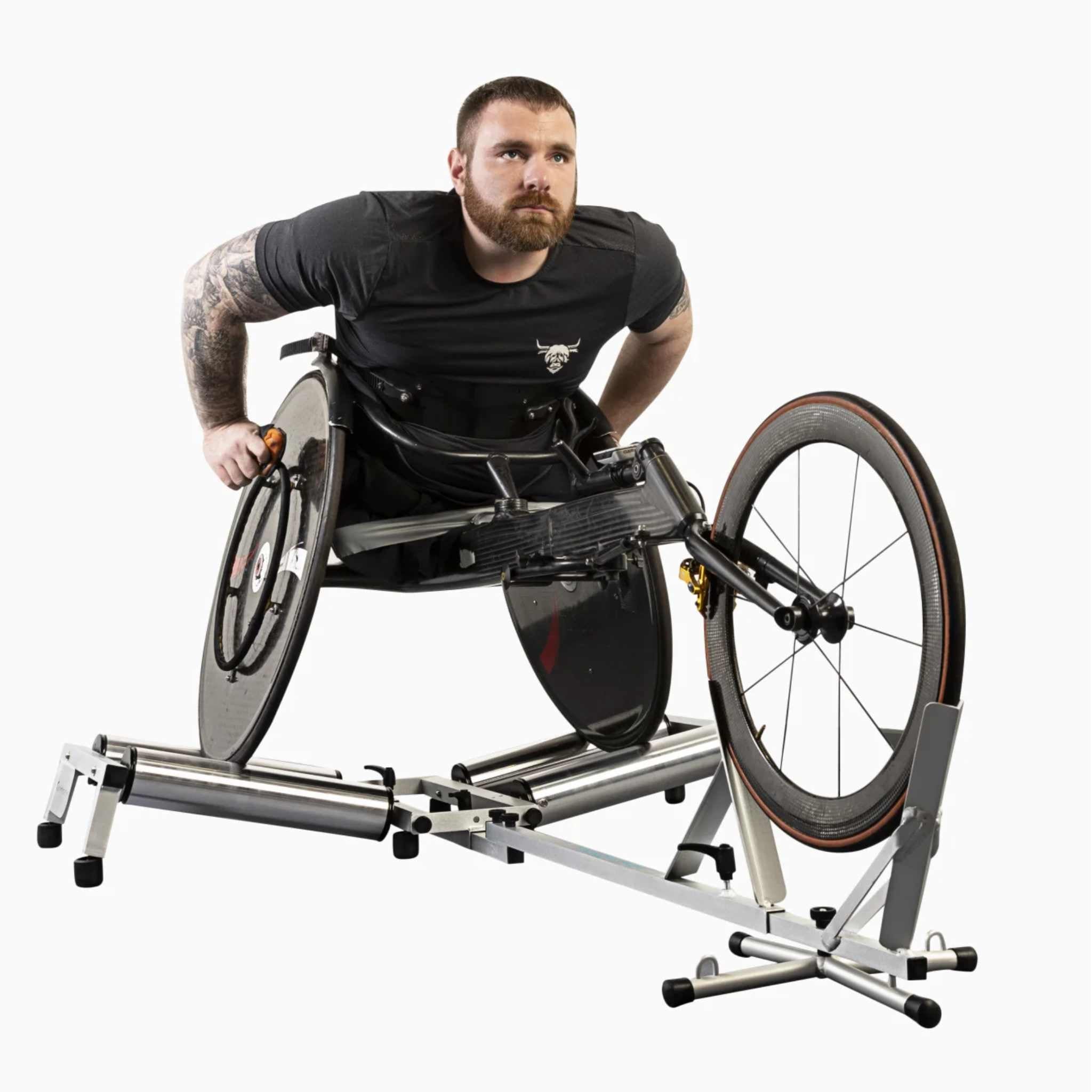 Man using an Invictus Active Race Roller in a racing wheelchair on a white background