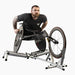 Man using an Invictus Active Race Roller in a racing wheelchair on a white background