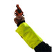 A high-visibility neon yellow protective arm sleeve worn on a person's arm, holding a blank orange-and-black revolver against a plain white background.